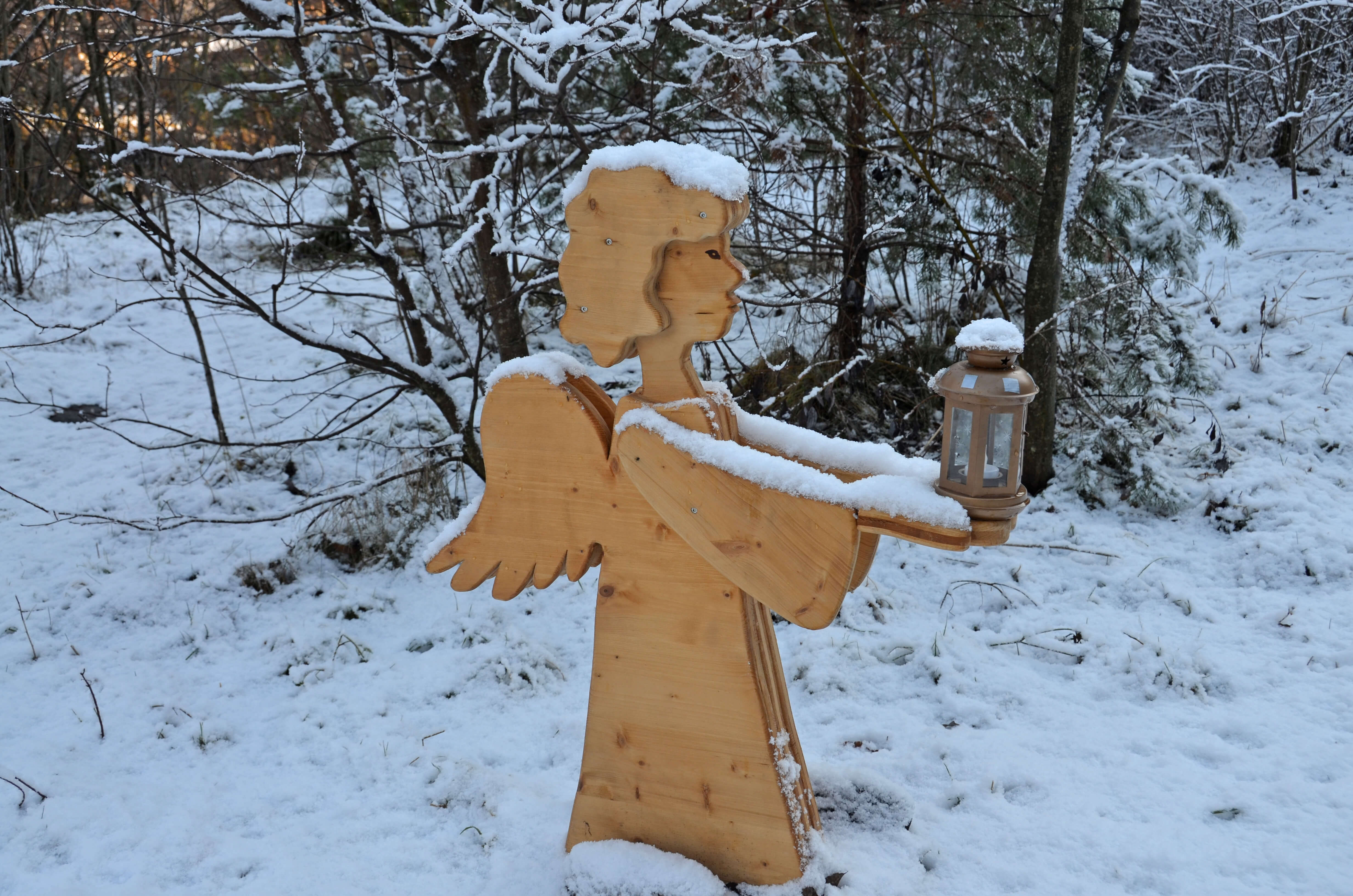 The wooden angel lights the way with his lantern 