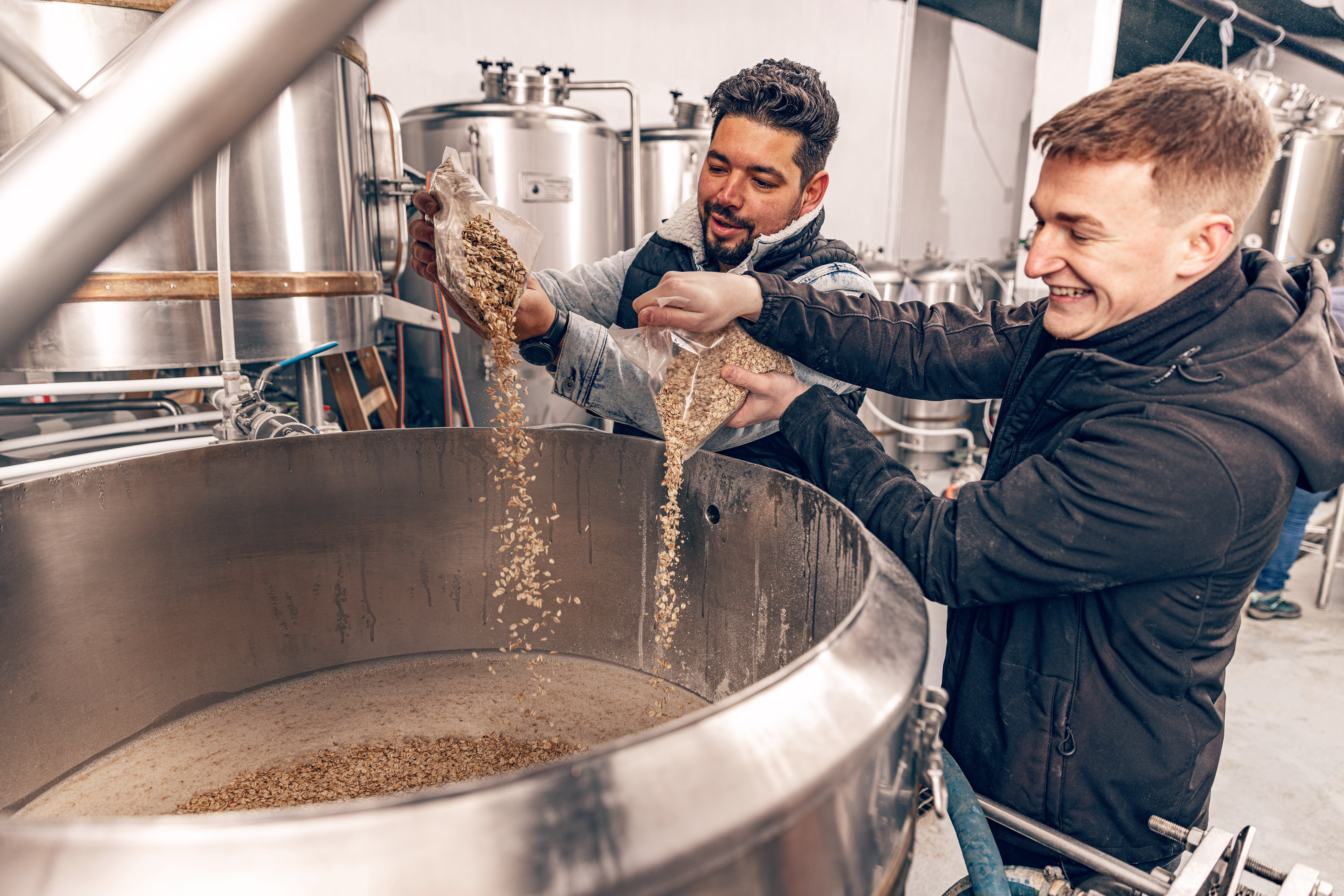 brewmasters-pours-malted-grain.jpg