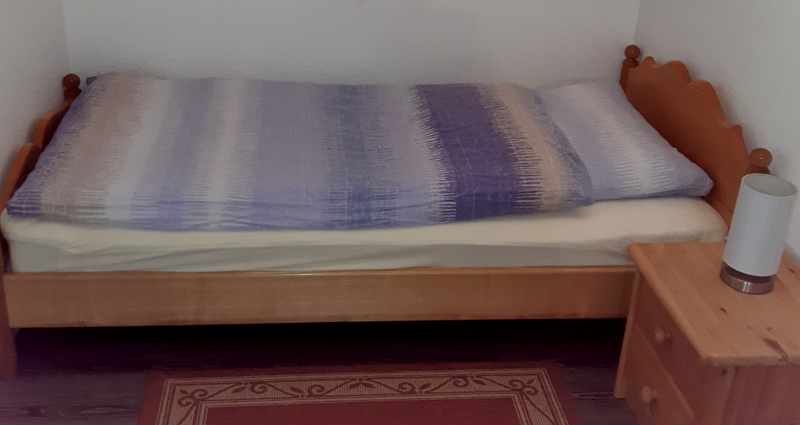 Ein kuscheliges Bett im gemütlichen Ferienhaus Hein's Hus